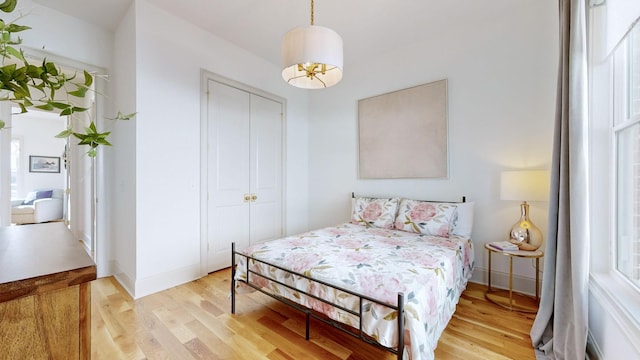 bedroom featuring a closet and light hardwood / wood-style flooring