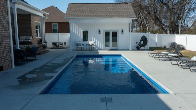 view of swimming pool with an outbuilding and a patio