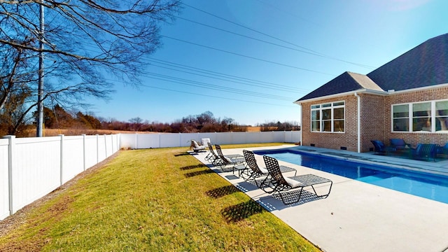 view of swimming pool featuring a patio area and a lawn