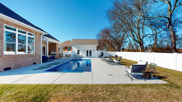 view of swimming pool with an outdoor structure, a patio, and a lawn