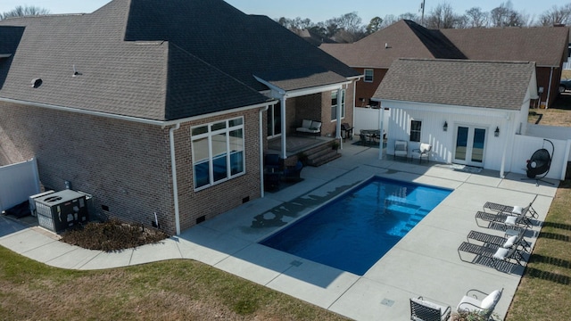 view of swimming pool featuring a patio area and french doors