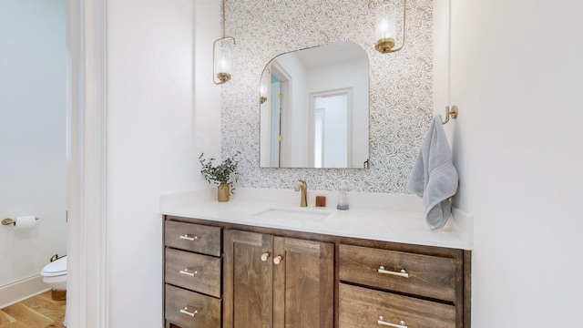 bathroom featuring hardwood / wood-style flooring, vanity, and toilet