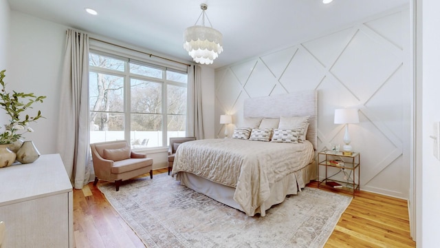 bedroom featuring a notable chandelier and light hardwood / wood-style flooring