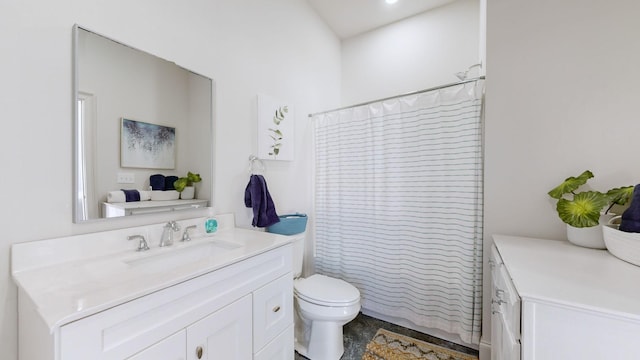 bathroom with walk in shower, vanity, and toilet