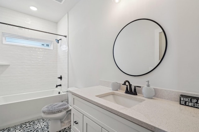 full bathroom with tiled shower / bath combo, vanity, and toilet