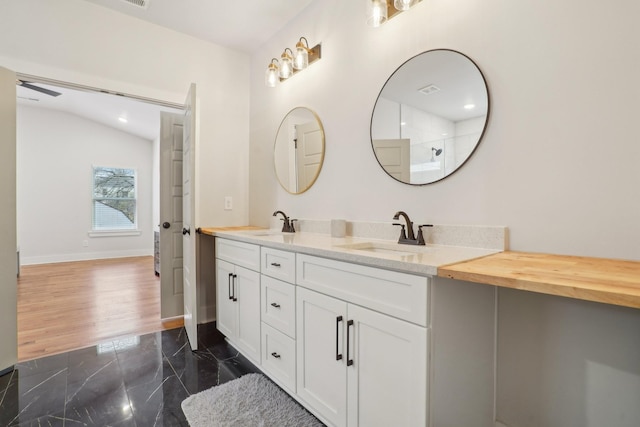 bathroom with vanity and a shower