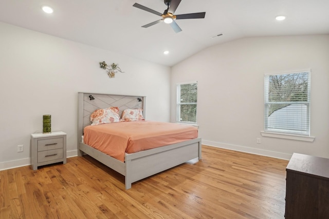 bedroom with ceiling fan, lofted ceiling, and light wood-type flooring