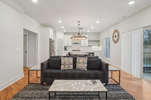 living room with sink and dark hardwood / wood-style floors