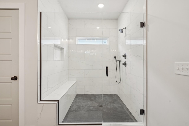 bathroom with a shower with door