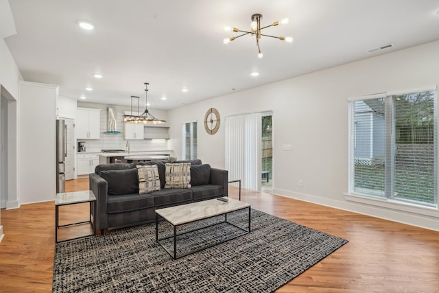 living room featuring a chandelier and hardwood / wood-style floors