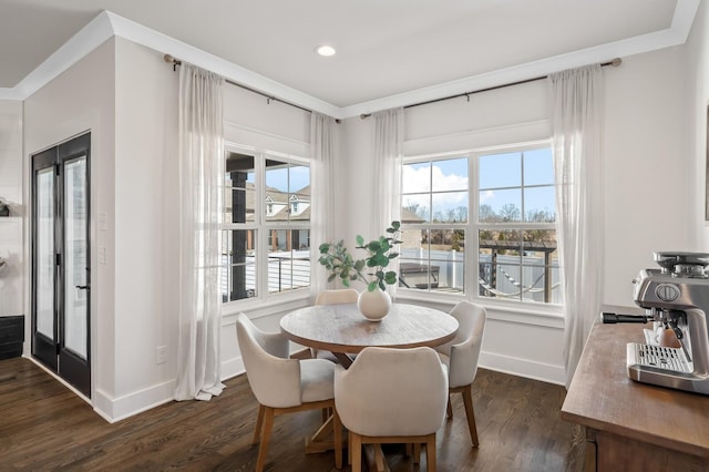 dining room featuring ornamental molding and dark hardwood / wood-style floors