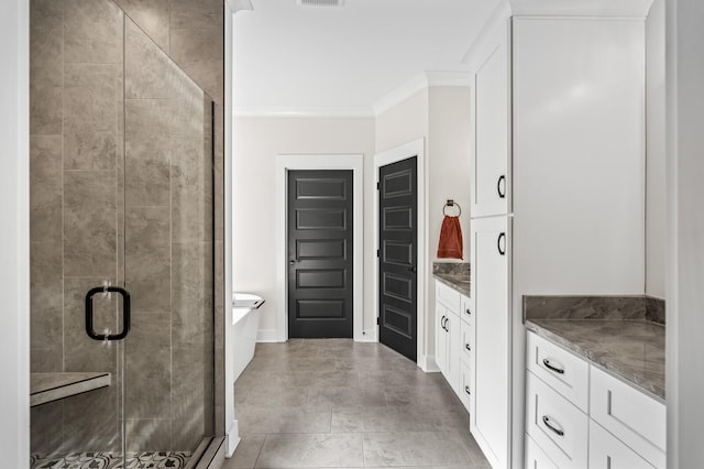 bathroom featuring vanity, crown molding, and a shower with shower door