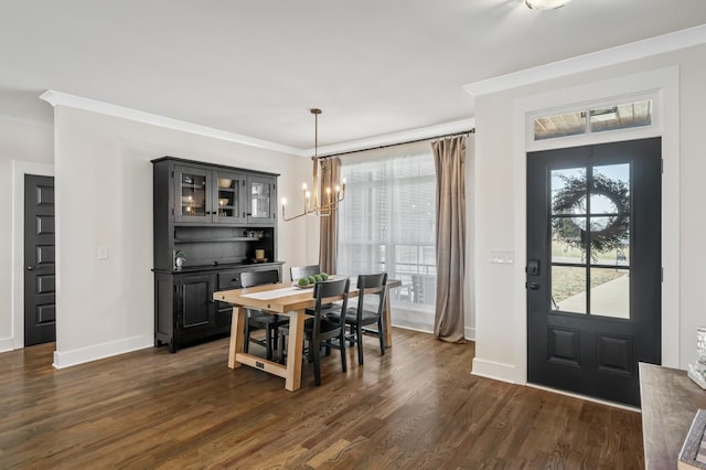 dining area featuring ornamental molding, dark hardwood / wood-style floors, and a chandelier