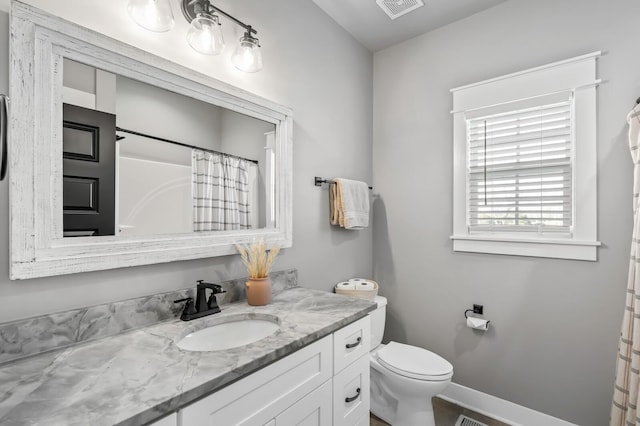 bathroom featuring vanity, toilet, and a shower with shower curtain