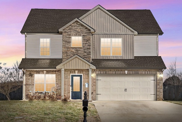 view of front of property with a garage and a yard