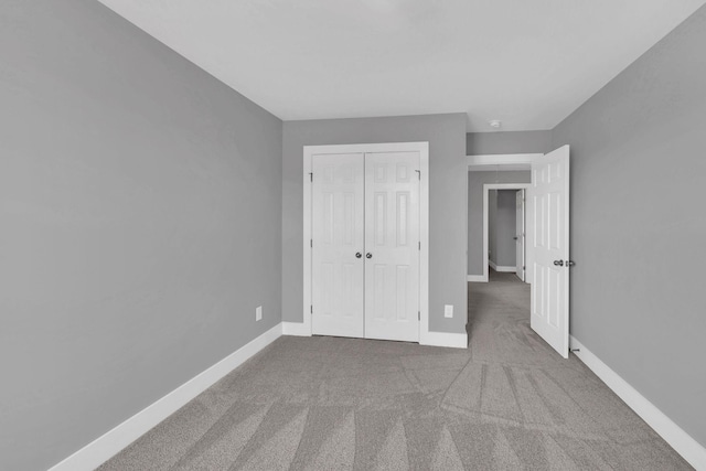 unfurnished bedroom featuring a closet and carpet flooring