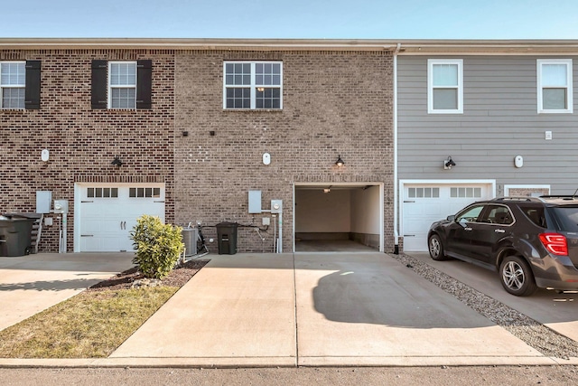 townhome / multi-family property featuring a garage and central AC