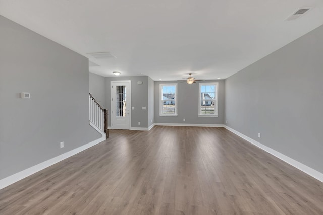 unfurnished living room with ceiling fan and light wood-type flooring