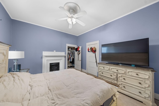 bedroom featuring ornamental molding, ceiling fan, and a closet