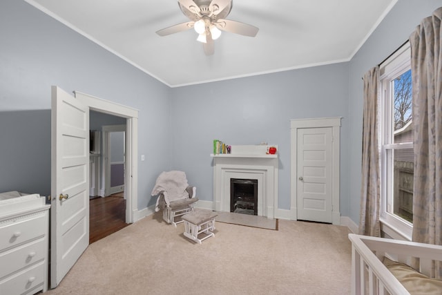 sitting room featuring ornamental molding, light colored carpet, and ceiling fan