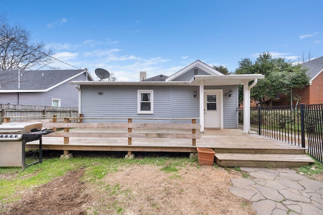 rear view of house featuring a deck