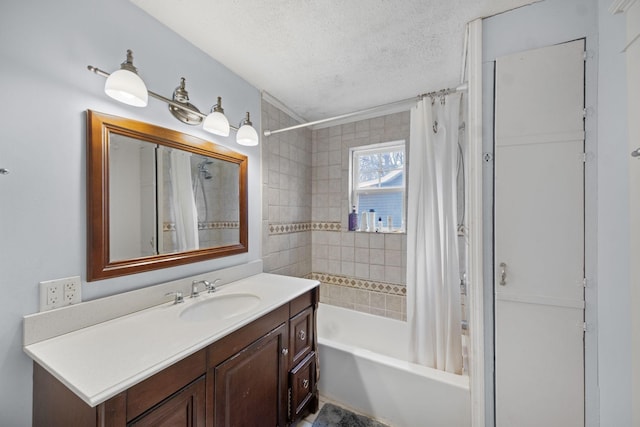 bathroom featuring shower / tub combo, vanity, and a textured ceiling