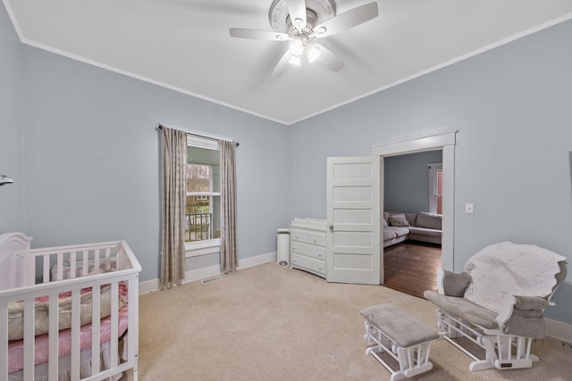 bedroom featuring ornamental molding, carpet floors, and ceiling fan