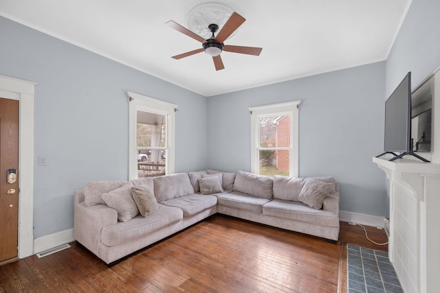 living room with dark hardwood / wood-style flooring and ceiling fan