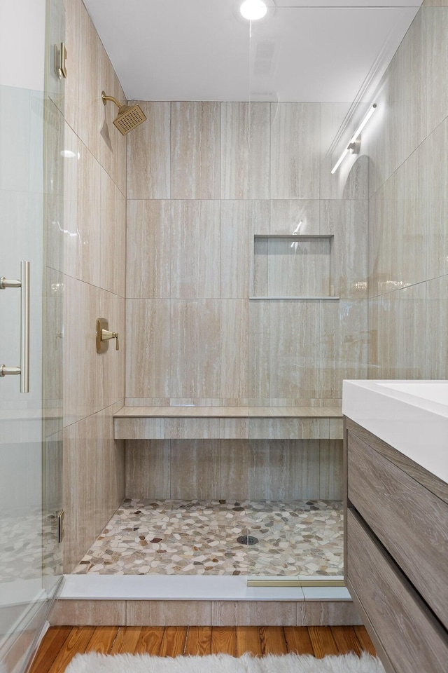 bathroom featuring vanity and an enclosed shower