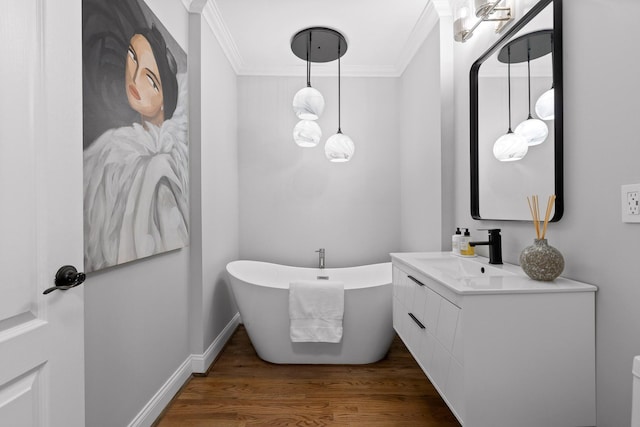 bathroom featuring vanity, a bath, crown molding, and wood-type flooring