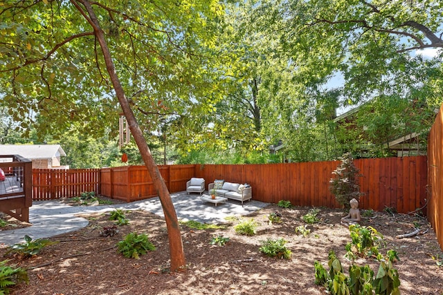 view of yard with an outdoor living space and a patio