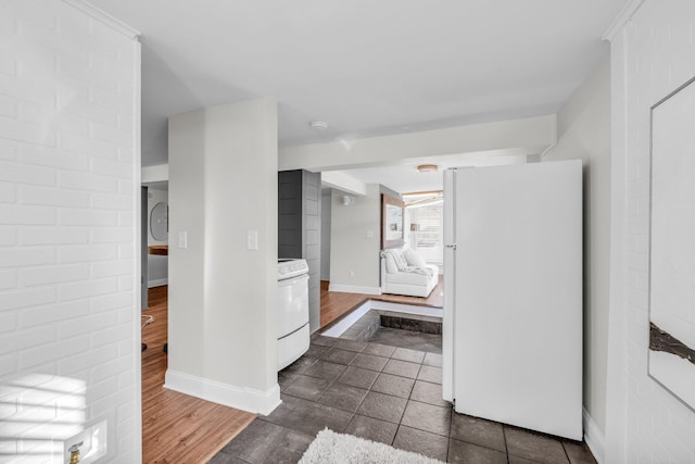 bathroom with washer / clothes dryer and hardwood / wood-style flooring