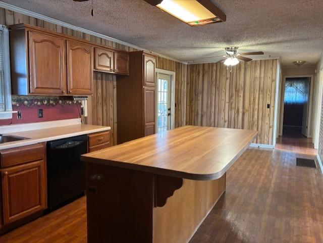 kitchen featuring ceiling fan, a center island, black dishwasher, and butcher block countertops