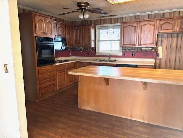 kitchen with dark hardwood / wood-style flooring, ceiling fan, wood counters, and black appliances