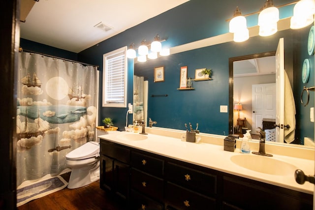 bathroom featuring vanity, hardwood / wood-style floors, toilet, and walk in shower