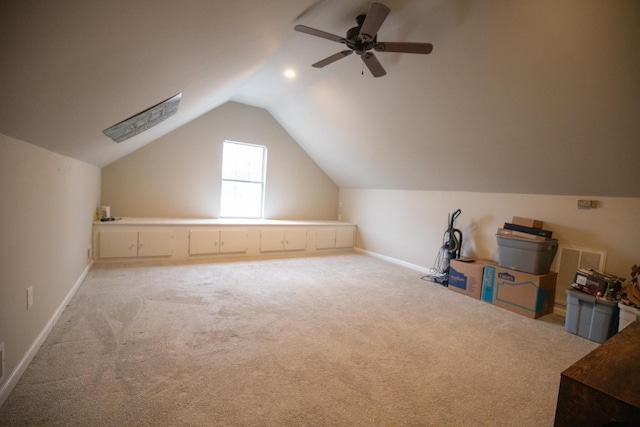 bonus room with lofted ceiling and light carpet