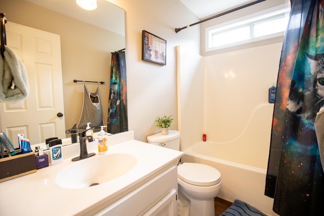 full bathroom with vanity, shower / tub combo, and toilet