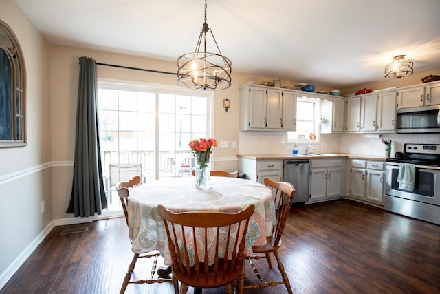 dining space with dark hardwood / wood-style flooring and sink