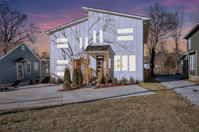 view of front facade featuring roof with shingles and board and batten siding