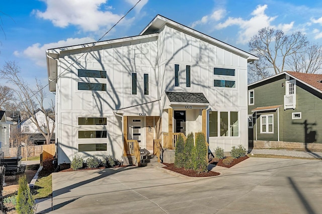 view of front facade featuring fence and board and batten siding