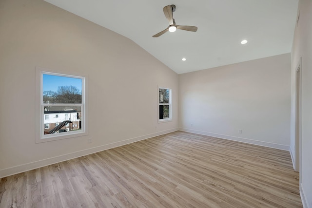 empty room featuring recessed lighting, light wood-style floors, a ceiling fan, high vaulted ceiling, and baseboards