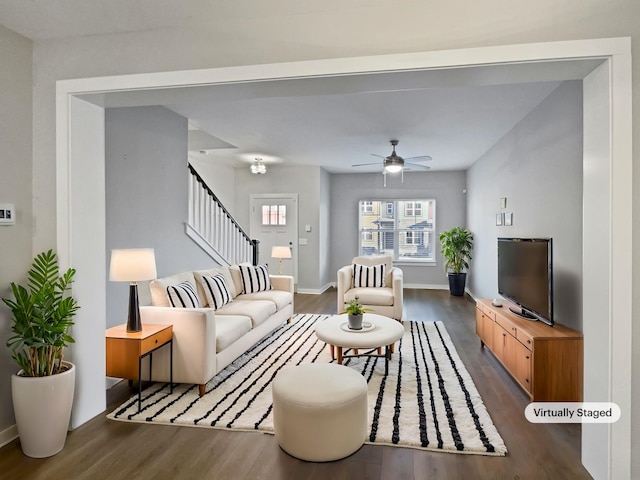 living room featuring dark wood-type flooring and ceiling fan