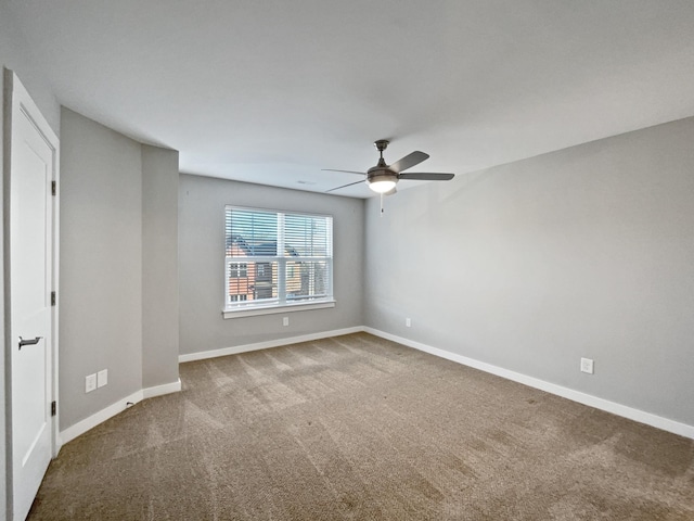 spare room featuring ceiling fan and carpet flooring