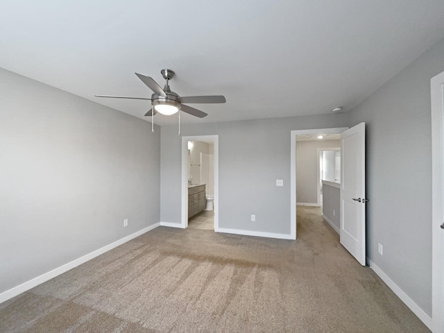 unfurnished bedroom with ceiling fan, connected bathroom, and light carpet