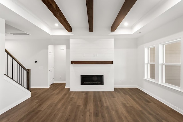 unfurnished living room with dark hardwood / wood-style flooring and beam ceiling