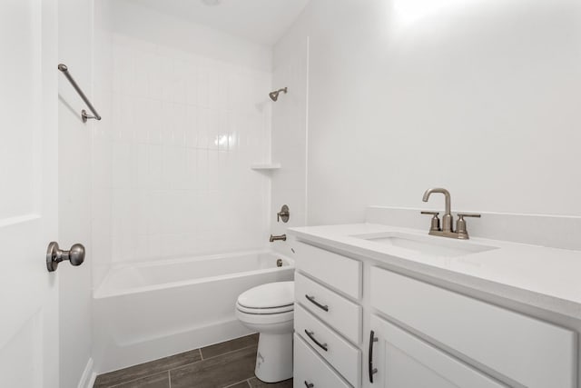 full bathroom with vanity, tiled shower / bath combo, and toilet