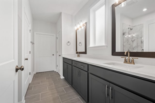 bathroom featuring vanity and tiled shower