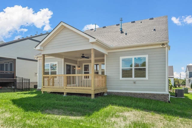 rear view of property with ceiling fan, a yard, central AC unit, and a deck