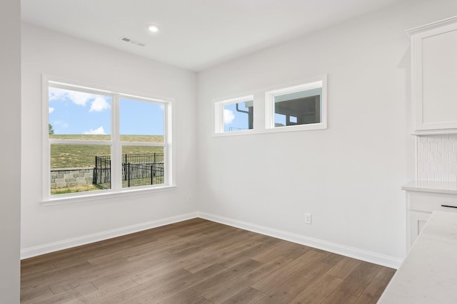 spare room featuring dark wood-type flooring