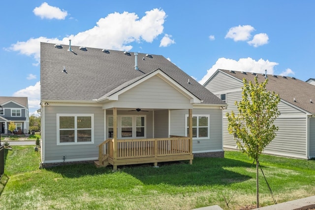 rear view of house featuring a yard and ceiling fan